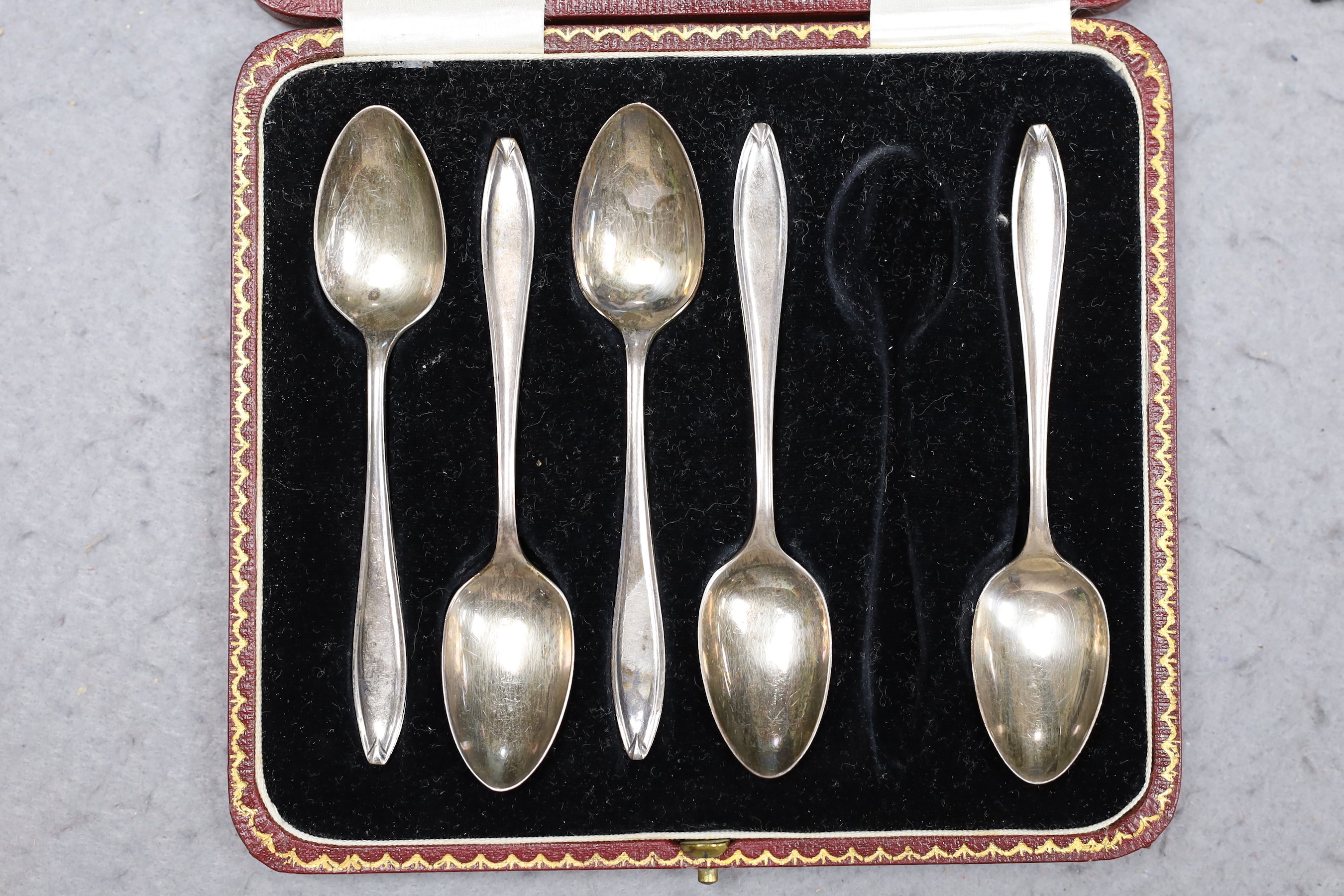 A Victorian silver hip flask with lockable cap, engraved Hogg family crest, London 1894, together with a cased part-set of five silver coffee spoons, Sheffield. 1923